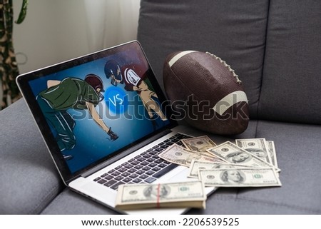 Football ball and money. video game at home