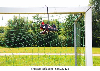 Football Boots Hanging On A Post 