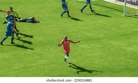 Football Championship: Red Team Forward Shoots: Kicks the Ball and Scores the Goal. Goalkeeper Fails to Catch Ball. Winning the Match and Game, Players Celebrate Tournament Victory