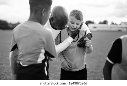 Football Coach With His Students