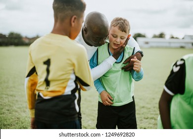 Football Coach With His Students