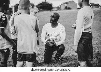 Football Coach Instructing His Students