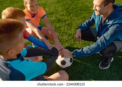 Football coach motivating junior soccer team before match - Powered by Shutterstock