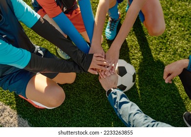 Football coach motivating junior football team before match - Powered by Shutterstock