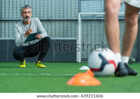 football coach training football player