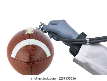 Football Concussion Concept: Closeup Of An American Football With A Doctors Hand Holding A Stethoscope Against The Ball, Isolated On White.