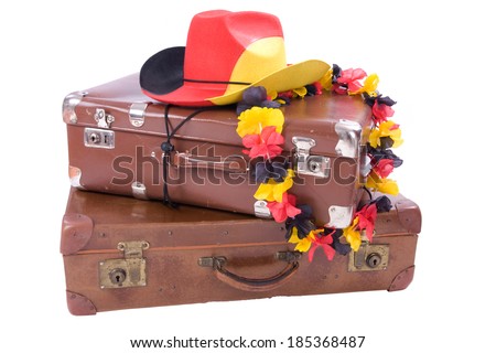 Football Cowboy Hut with flower necklace over two old suitcases