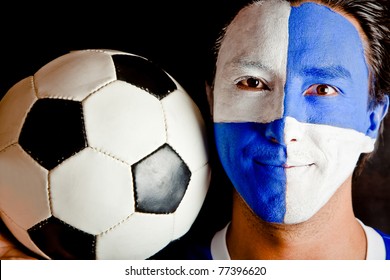 Football Fan With A Blue And White Flag Painted On His Face