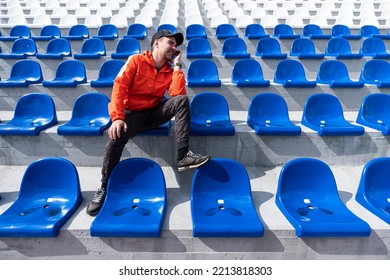 Football fan clapping on the podium of the stadium. one single fan at the stadium is rooting for his favorite football team during quarantine or lockdown from the covid 19 coronavirus - Shutterstock ID 2213818303