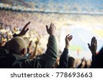 Football fans clapping on the podium of the stadium