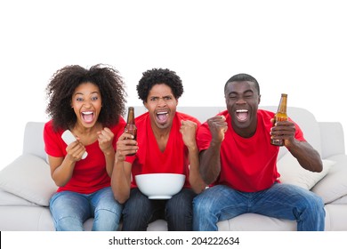 Football Fans In Red Cheering On The Sofa On White Background