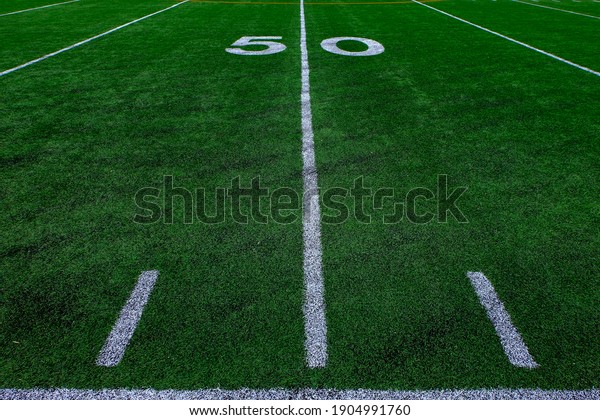 Football field green grass white yard markers to\
touchdown competition\
game