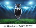 Football field with soccer cup with floodlights. Football championship final, creative idea. Tournament and World Championship. Euro 2024