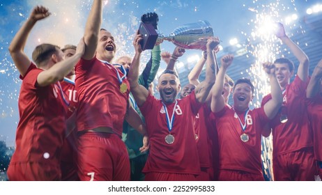 Football Finals Tournament Winning Team Celebrates Victory Cheering and Lifting Trophy Prize on Stadium. Happy Soccer Players Champions of International Championship Cup. Fireworks Shot.