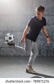 Football freestyle. Young man practices with soccer ball