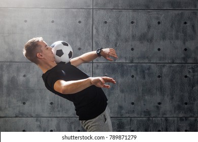 Football Freestyle. Young Man Practices With Soccer Ball