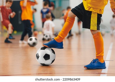 Football Futsal Training For Children. Soccer Training Drill. Indoor Soccer Young Player With A Soccer Ball In A Sports Hall. Player In Yellow Uniform. Sport Background