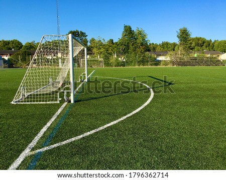 A football goal with white stripes against the green plastic grass. Stockholm, Sweden.