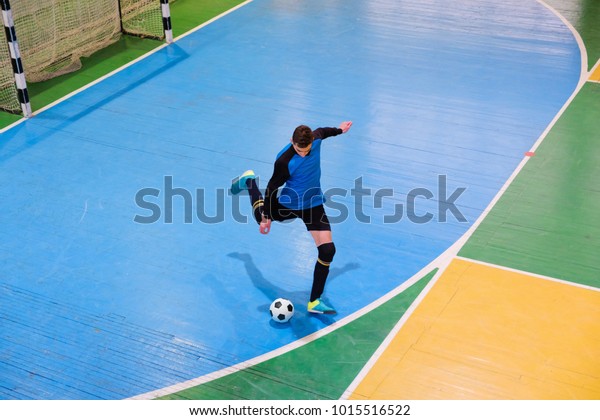 Football goalkeeper on goal,\
field, Small Futsal ball field in the gym indoor, Soccer sport\
field