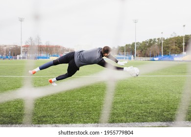 Football Goalkeeper Throws The Ball Into The Goal - Quick Reaction Of A Professional Player