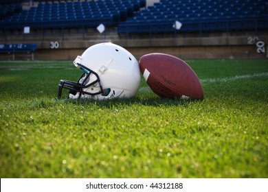 Football and helmet on a field - Powered by Shutterstock