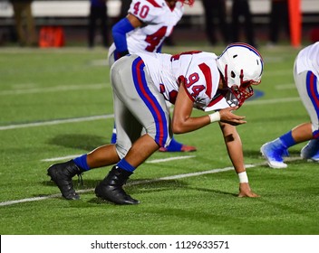 Football Lineman Blocking And Rushing During A Football Game