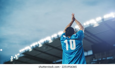 Football Match Championship: Portrait of Soccer Player Standing, Posing, Smiling, Raising Hands to Cheer. Professional Hispanic Footballer, Champion Ready to Win Cup, Tournament. Medium Back Shot - Powered by Shutterstock