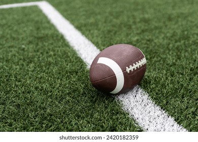 Football on hash marks of high school turf football field - Powered by Shutterstock