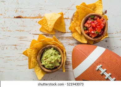 Football party food, super bowl day, nachos salsa guacamole, top view  on wood background - Powered by Shutterstock