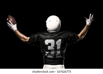 Football Player with a black uniform, on a black background.