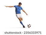 Football player in a blue jersey top running and preparing to kick a ball isolated on white background