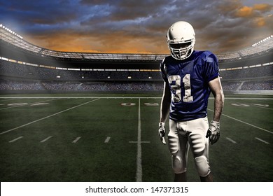 Football player with a blue uniform, in a stadium with fans wearing blue uniform - Powered by Shutterstock