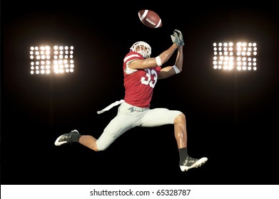 Football Player Catches Ball In Midair