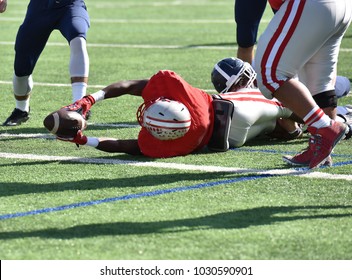 Football Player Diving Forward For A Touchdown During A Game