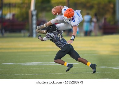 Football Player Gets Injured During A Tackle While Hurdling Over Another Player