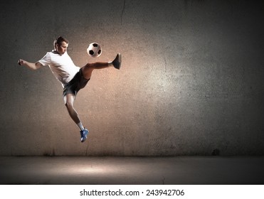 Football Player In High Jump Taking Ball