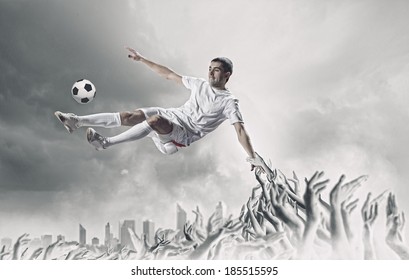 Football Player In Jump Kicking The Ball