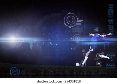 Football player kicking ball against blue dots on black background - Powered by Shutterstock