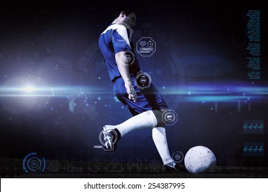 Football player kicking ball against blue dots on black background - Powered by Shutterstock