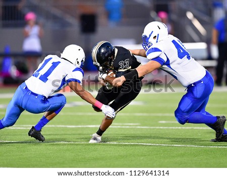 Football player making a tackle during a game