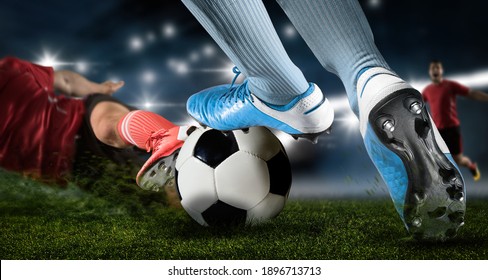 Football player man in action on dark arena background. Soccer player making sliding tackle - Powered by Shutterstock