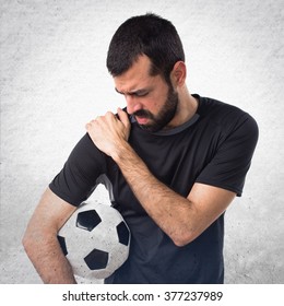 Football Player With Shoulder Pain Over Textured Background