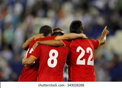 Football Players Hugging While Celebrate Goal In A Match