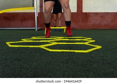 Football Players On A Hexagonal Speed And Agility Training Ladder Rings In The Field