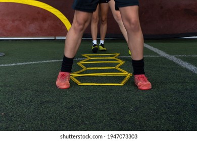 Football Players On A Hexagonal Speed And Agility Training Ladder Rings In The Field