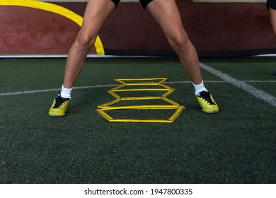 Football Players On A Hexagonal Speed And Agility Training Ladder Rings In The Field