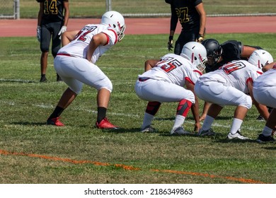 Football Players On The Line Waiting For The Snap Of The Football - American Football