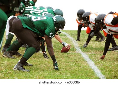 Football Players Ready To Snap The Ball Isolated On White Background