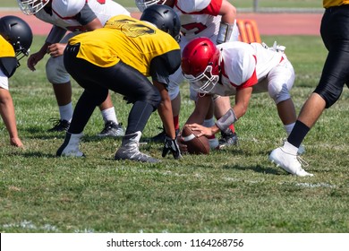 Football Players setting up for the play – Hike the ball  - Powered by Shutterstock