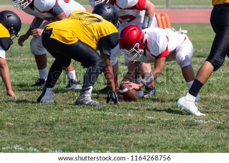 Football Players setting up for the play – Hike the ball 